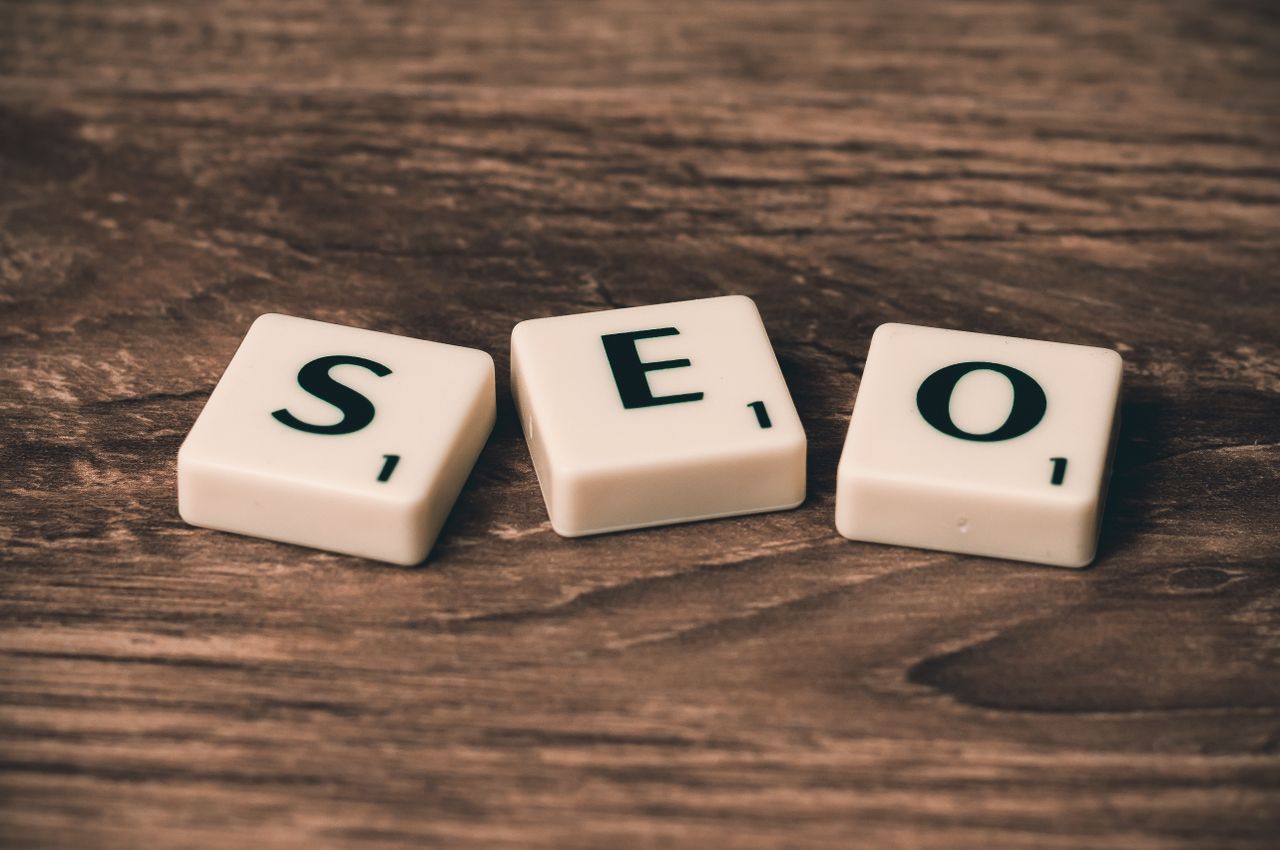 services-04 Scrabble tiles arranged to spell SEO on a wooden surface, well suited to digital marketing themes.